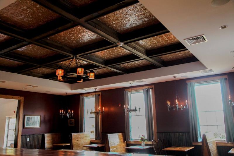 As you look around, your eyes will catch the gleam of gorgeous copper accents that surround the inviting fireplace and add a touch of elegance to the custom coffered ceiling, crafted by a local master carpenter.