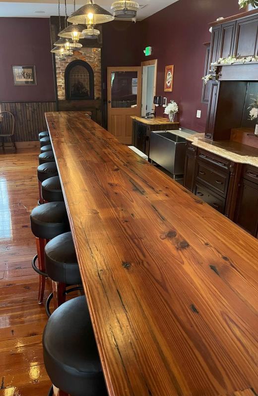Step into this space and you'll be wowed by the custom bar hewn from 100-year-old wood, giving off a rustic charm that's perfect for your Wedding. 